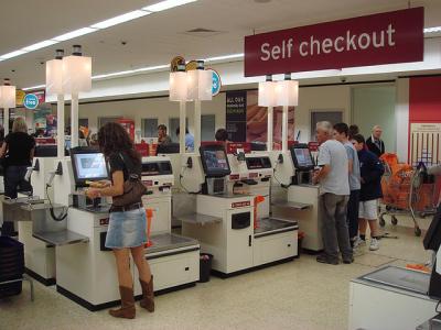 Many stores provide self-checkout machines for customers. (Photo: CC BY 2.0 <https://creativecommons.org/licenses/by/2.0>, via Wikimedia Commons.)