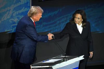 U.S. presidential candidates Donald Trump and Kamala Harris shake hands before a televised debate. (Photo via Facebook.)