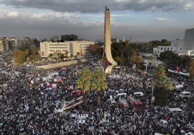 Thousands of Syrians celebrate the ousting of Bashar al-Assad's government in Damascus, Syria. (AP Photo/Hussein Malla)