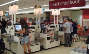 Many stores provide self-checkout machines for customers. (Photo: CC BY 2.0 <https://creativecommons.org/licenses/by/2.0>, via Wikimedia Commons.)