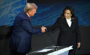 U.S. presidential candidates Donald Trump and Kamala Harris shake hands before a televised debate. (Photo via Facebook.)